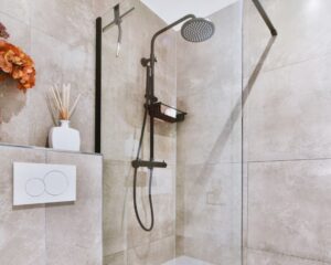A tiled walk-in shower adjacent to a wall for bathroom remodels in the city.