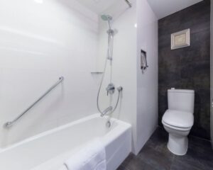 A City bathroom with a shower head and tub.