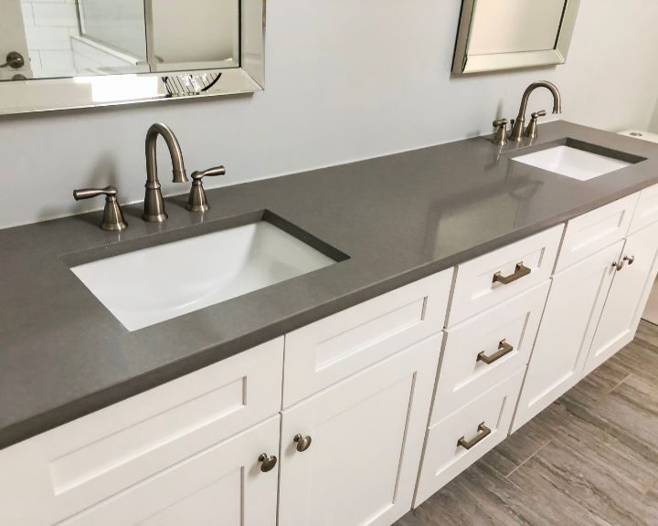 A City bathroom remodeled with dual sinks and a mirror.