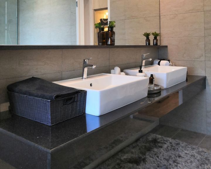 A city bathroom with two countertops and a large mirror.