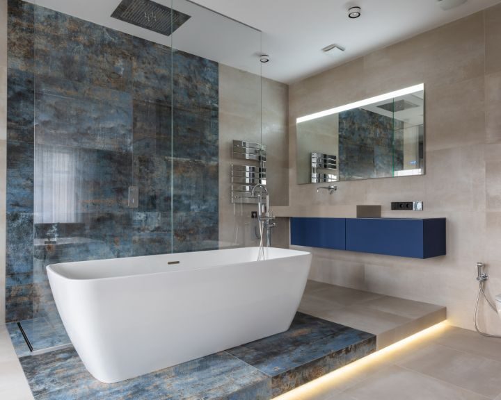 A City bathroom remodeled with a bathtub, sink, and mirror.