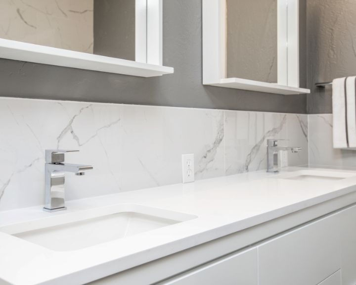 A City bathroom renovation featuring dual sinks and mirrors.