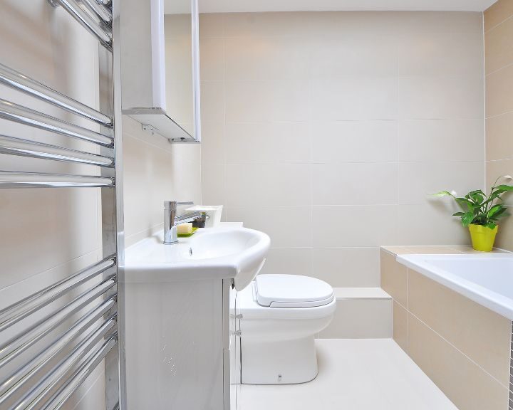 A city-inspired bathroom design featuring a sink, toilet and bathtub.